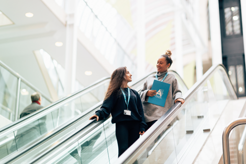 Arden University students on escalator at London study centre