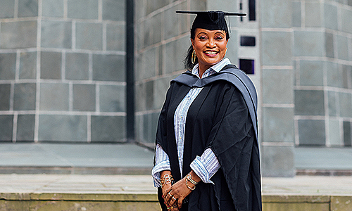 Arden University graduate in gown and mortar board