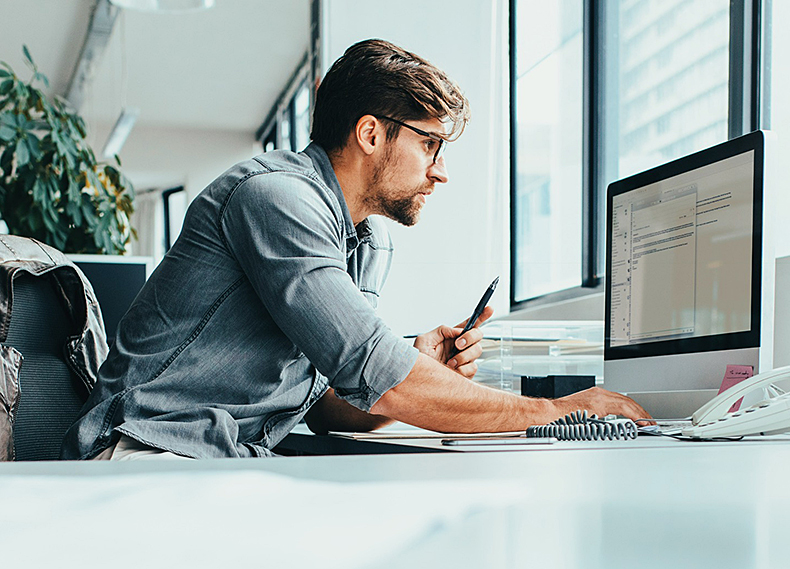 Arden University graduate working at his desk in Berlin