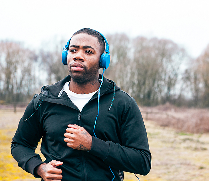Arden University student learning through headphones