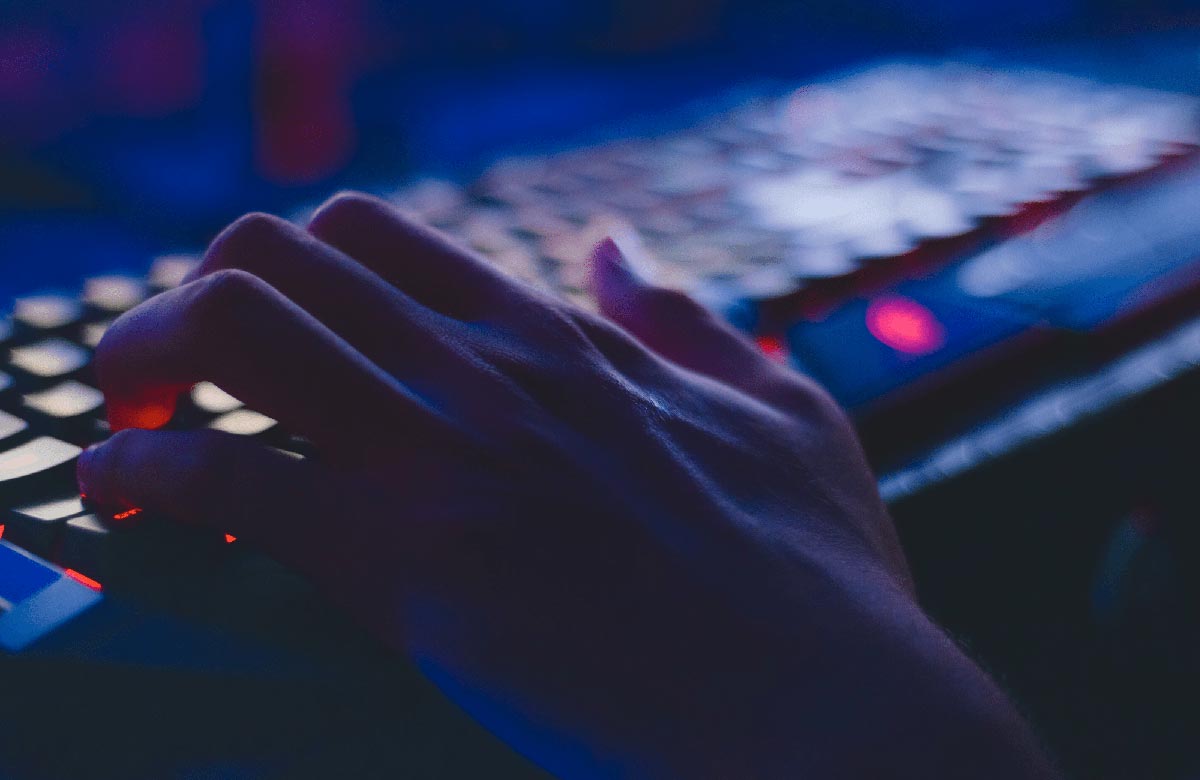 Hand typing on computer keyboard