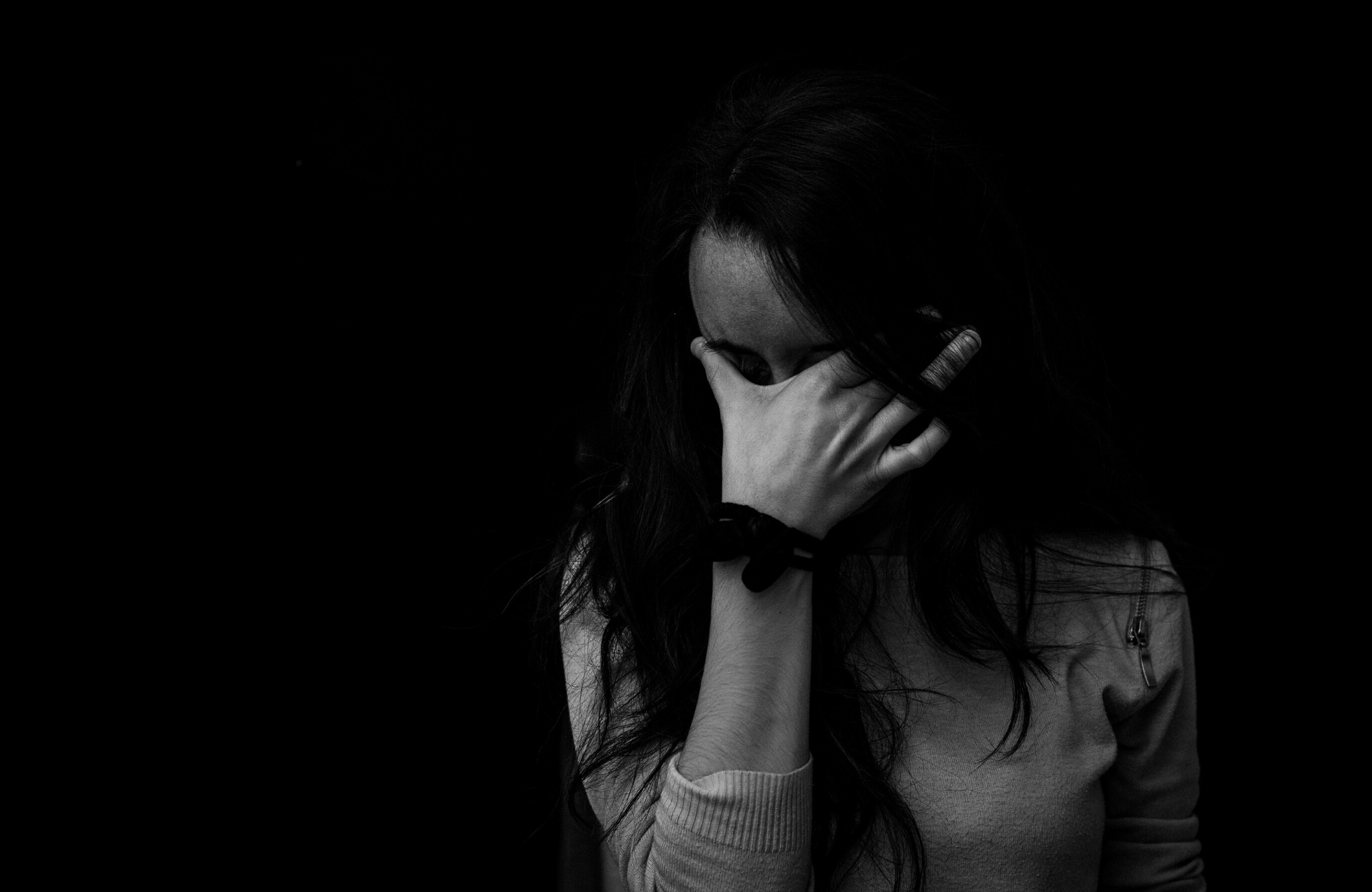 Woman with head in hands
