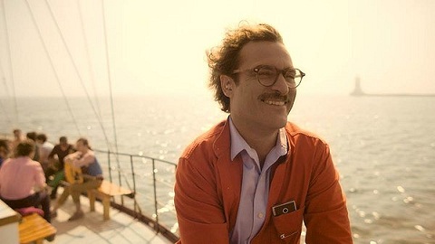 Man with a smile sitting on boat with wind blowing