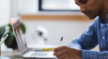 man writing at a desk