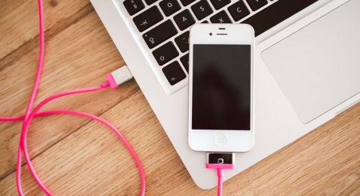 A cellphone plugged into a laptop