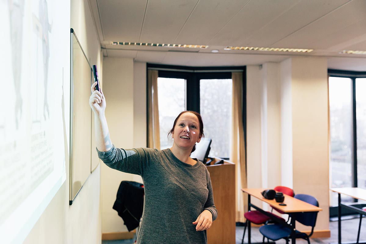 Teacher pointing at a chalkboard